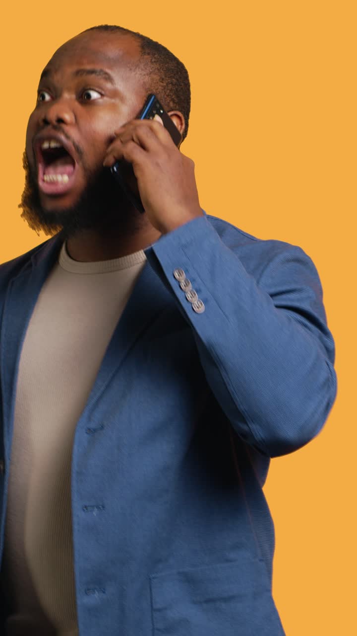 Vertical video Happy person enjoying talking with friends in phone call, studio background