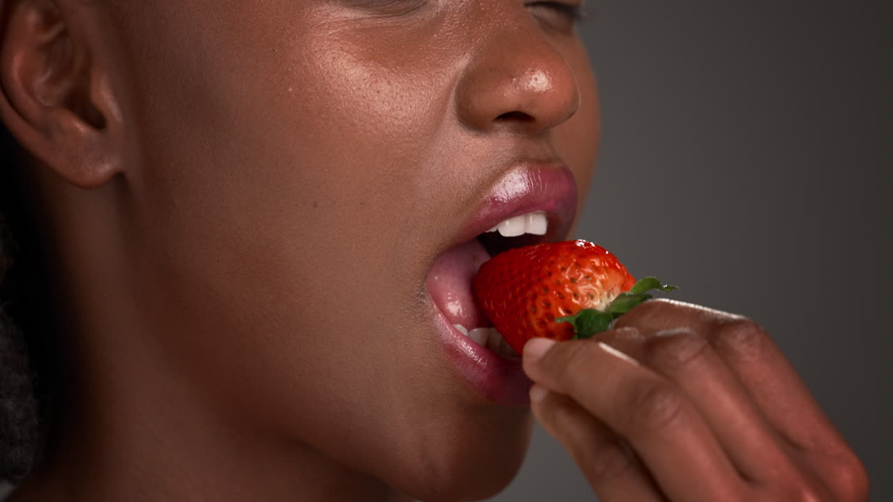 Woman eating a strawberry