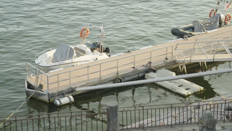 the speed boat that is tied up by the docks