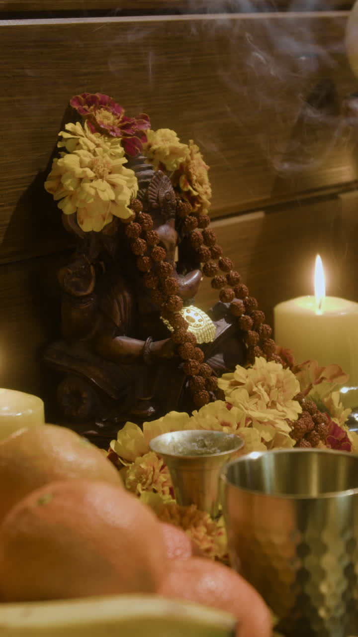 Ganesha Statue with Flowers and Candle