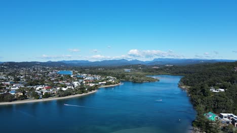 scenic panoramic view of a large inland river system with mountain peaks in the distance