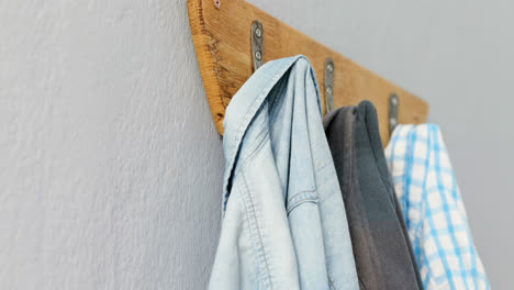 Shirts-hanging-on-hook-against-wall-4k