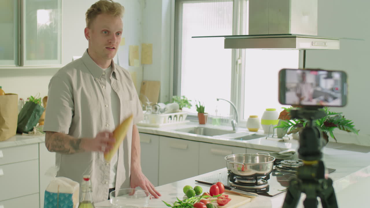 Food Blogger Filming Video Recipe in Kitchen with Smartphone