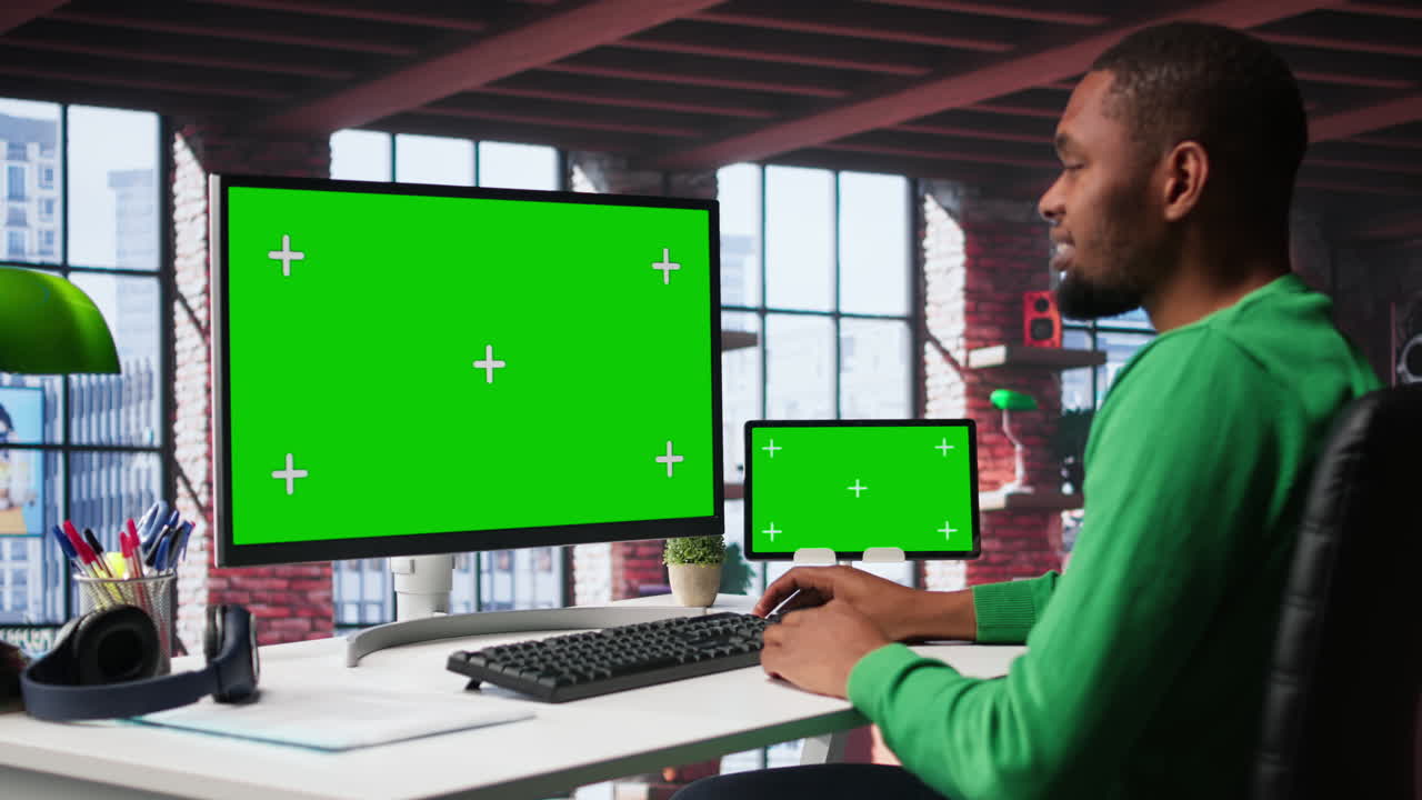 Vertical Video Black male worker in his loft using copy space PC to analyze sales reports