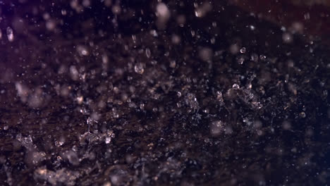 animation of water drops falling on black background