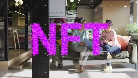 animation of purple nft text banner against two diverse women discussing together at office