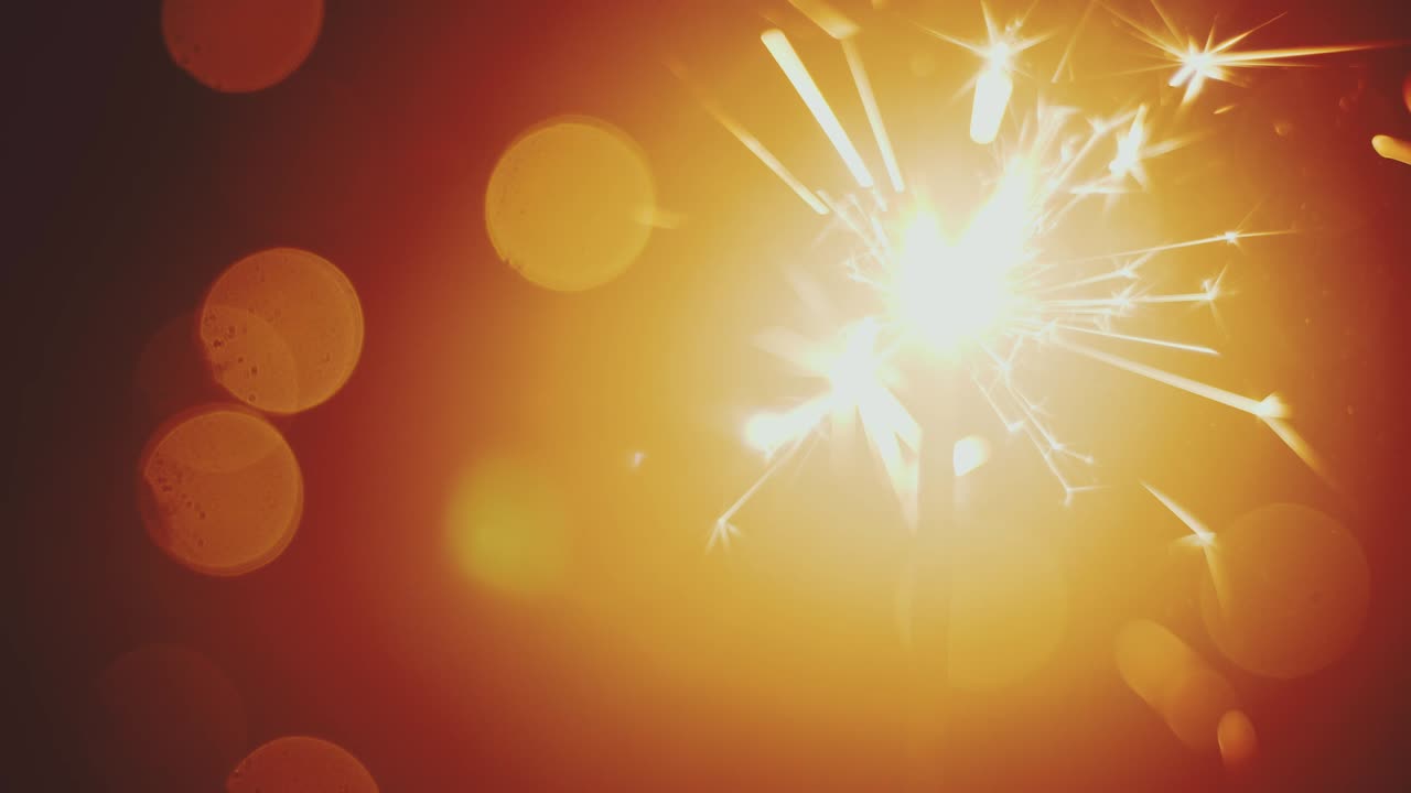 Cinemagraph of sparkler (bengal fire). Warm light, bokeh