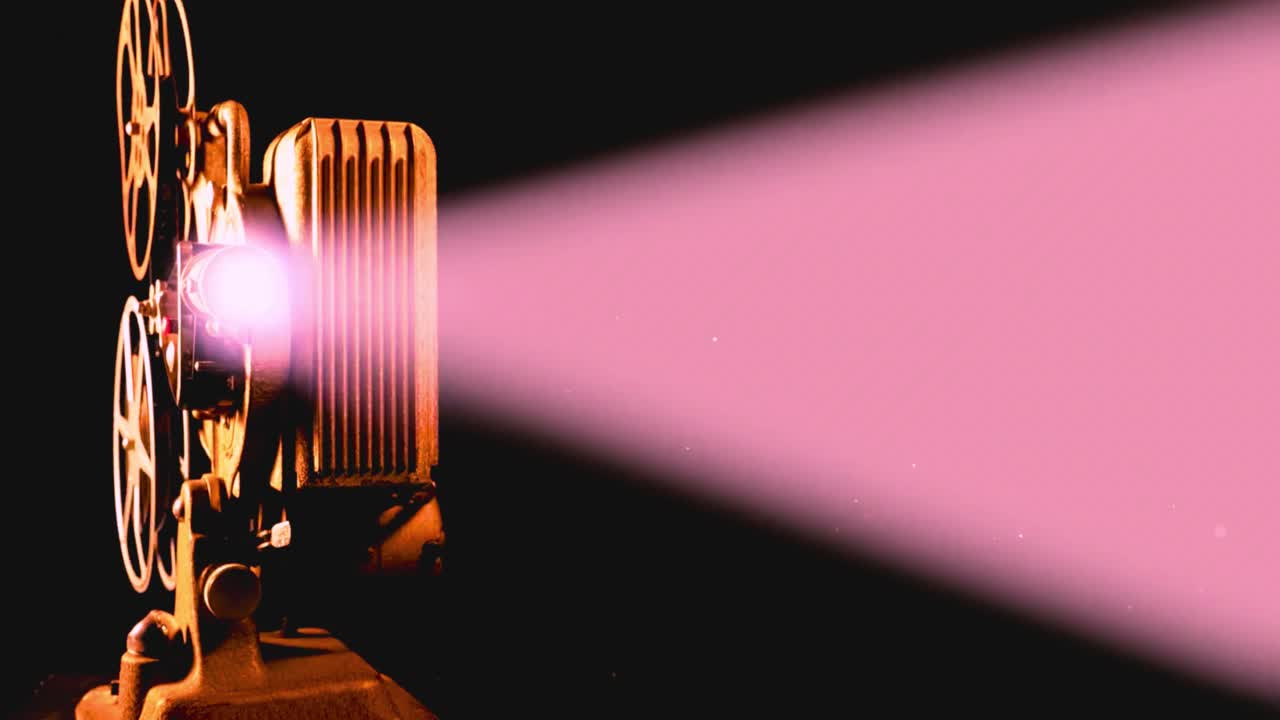 Vintage-Filmprojektor, der einen rosa Lichtstrahl in einem dunklen Raum aussendet