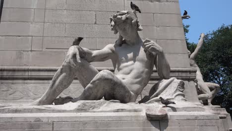 birds on a statue at the base of the christopher columbes statue in new york city