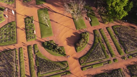 aerial drone circling view over people walking at rosedal rose gardens of palermo park in buenos aires, argentina