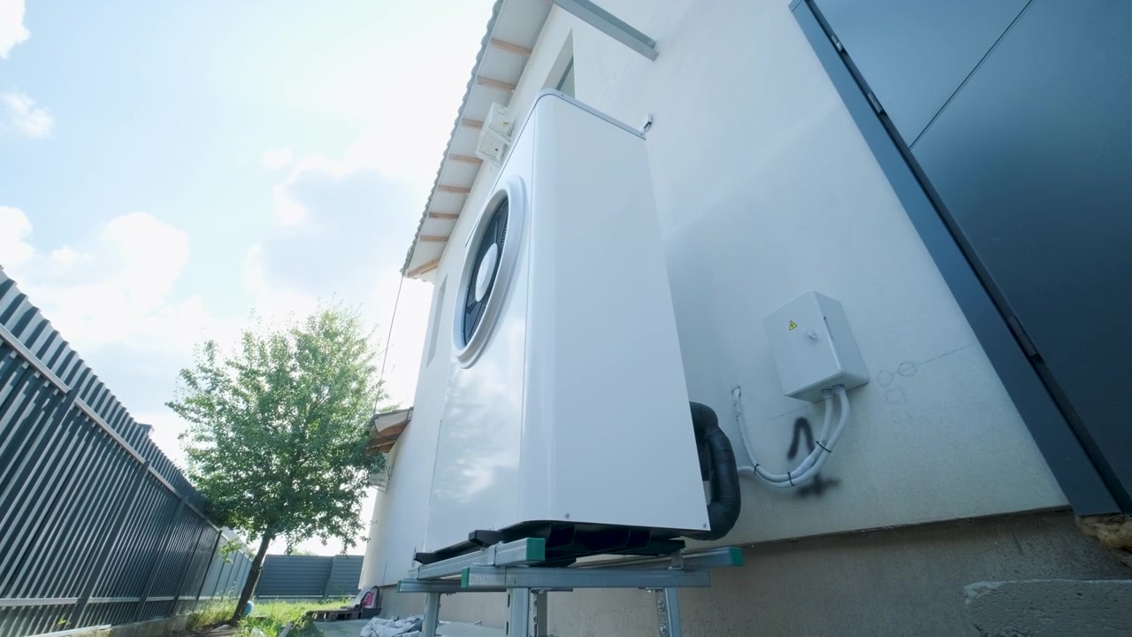 Modern Heat Pump Unit Installed Outside a Residential House