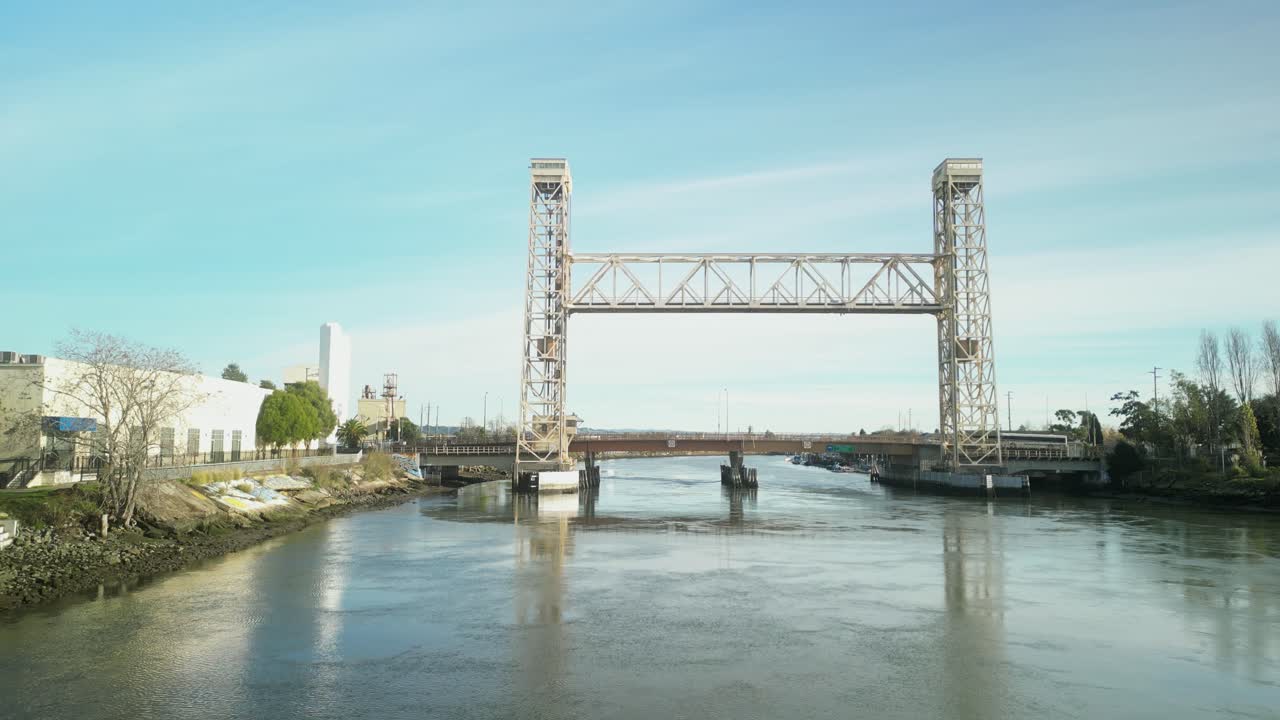 Aerial drone views display the Miller Sweeney Bridge at Alameda’s waterfront in the late afternoon.