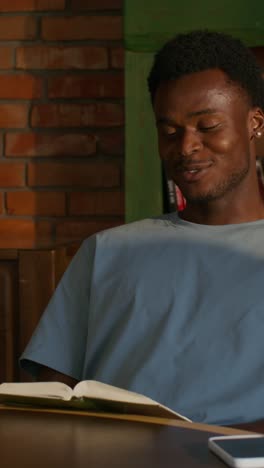 man reading in a cafe