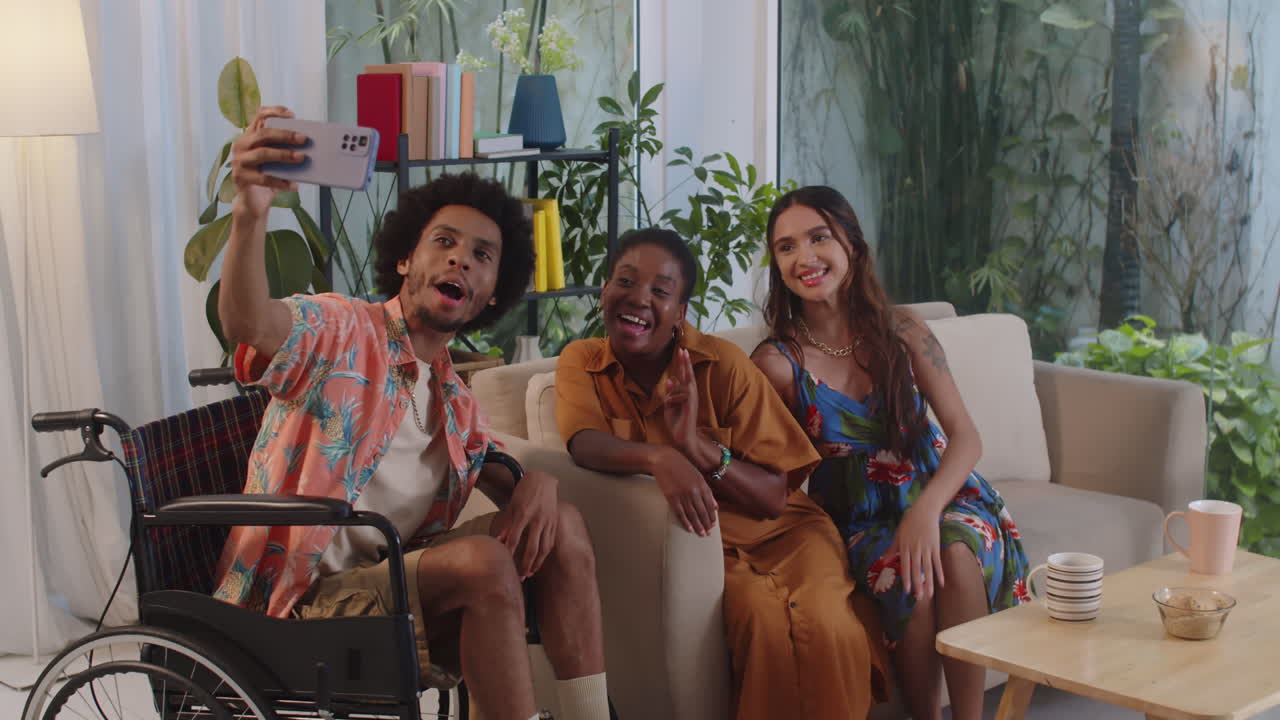 Man with Disability and Female Friends Taking Selfie on Phone