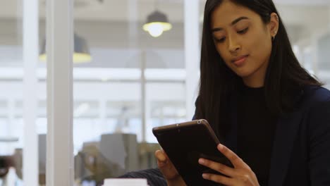 Businesswoman-using-digital-tablet-in-office-4k