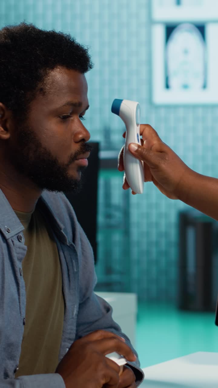 Doctor Taking Patient's Temperature with Digital Thermometer