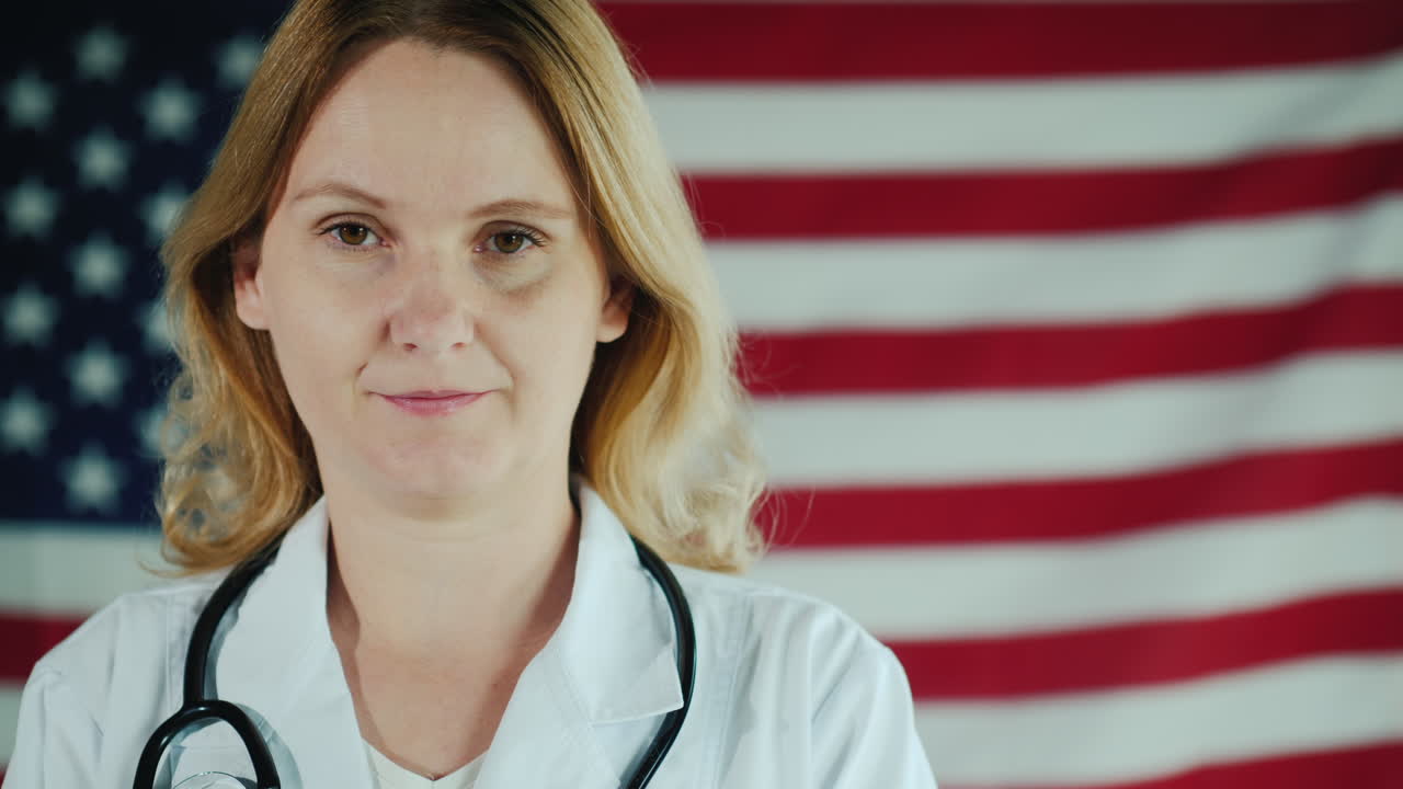 Ritratto di una giovane dottoressa sullo sfondo della bandiera americana