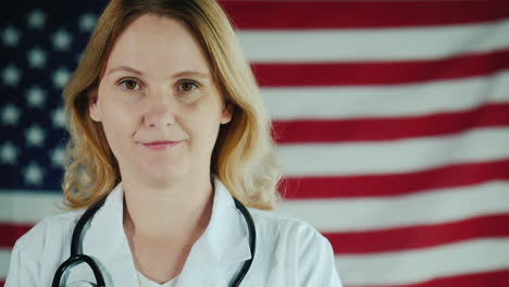 Portrait-Of-A-Young-Female-Doctor-Against-The-Backdrop-Of-The-American-Flag