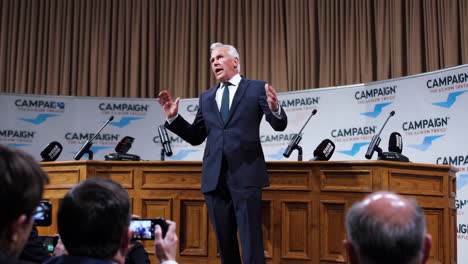 man delivers speech at political campaign event