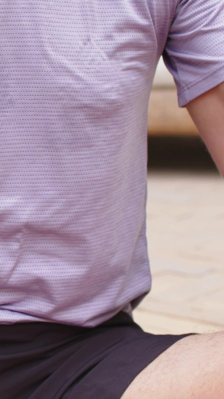 Video verticale: Dopo il segnale, un uomo in camicia si allunga a casa sul tappetino per esercizi di respirazione, con il partner che compare.