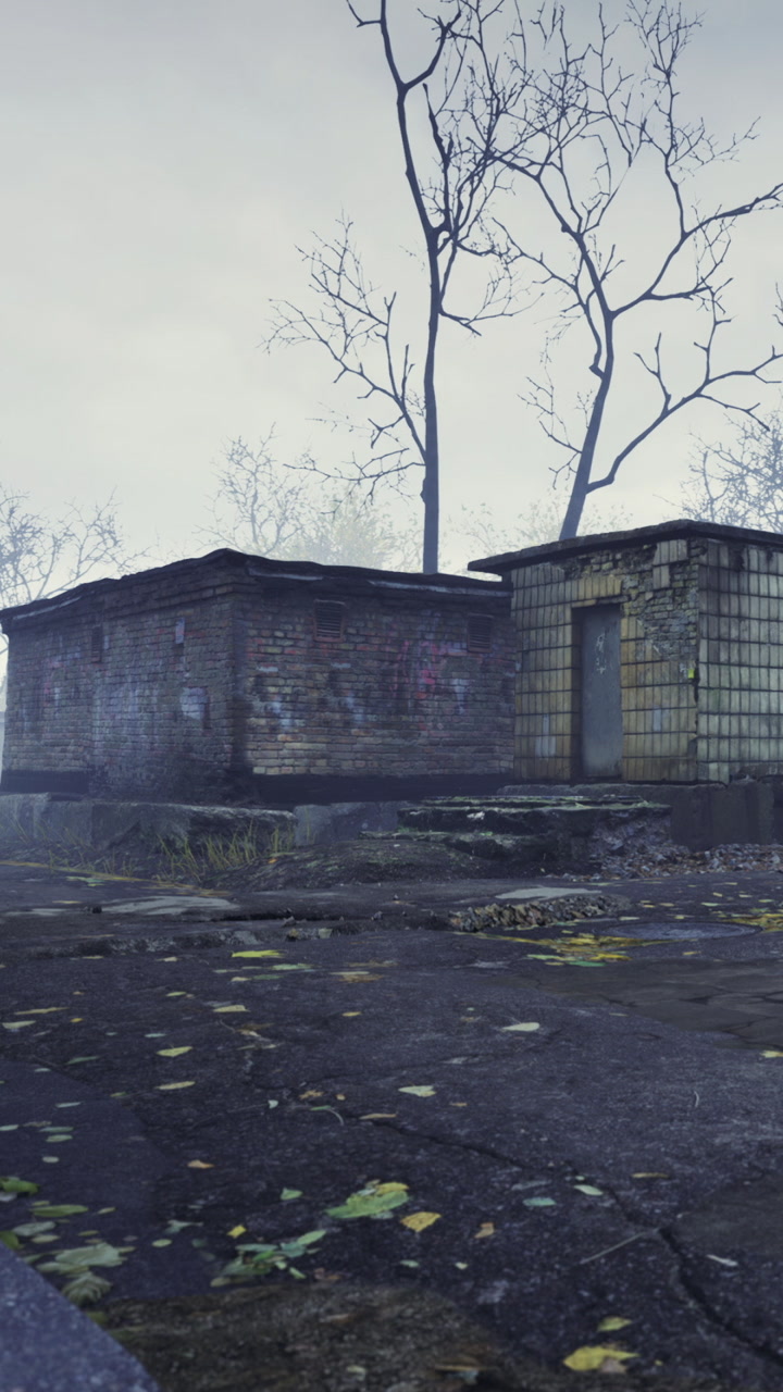 Old brick building in abandoned area with trees and cloudy sky