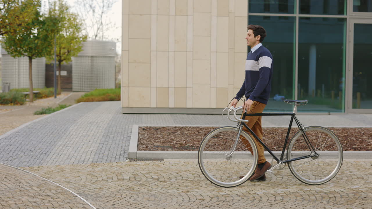 Man with Bicycle Walking Down a City Street