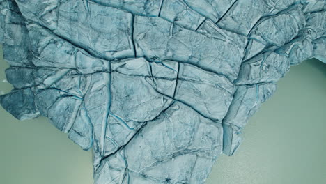 glacier melting in a lake below due to climate change in the alps, view from above