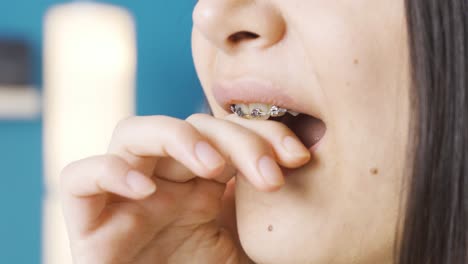 young woman with braces has a toothache.