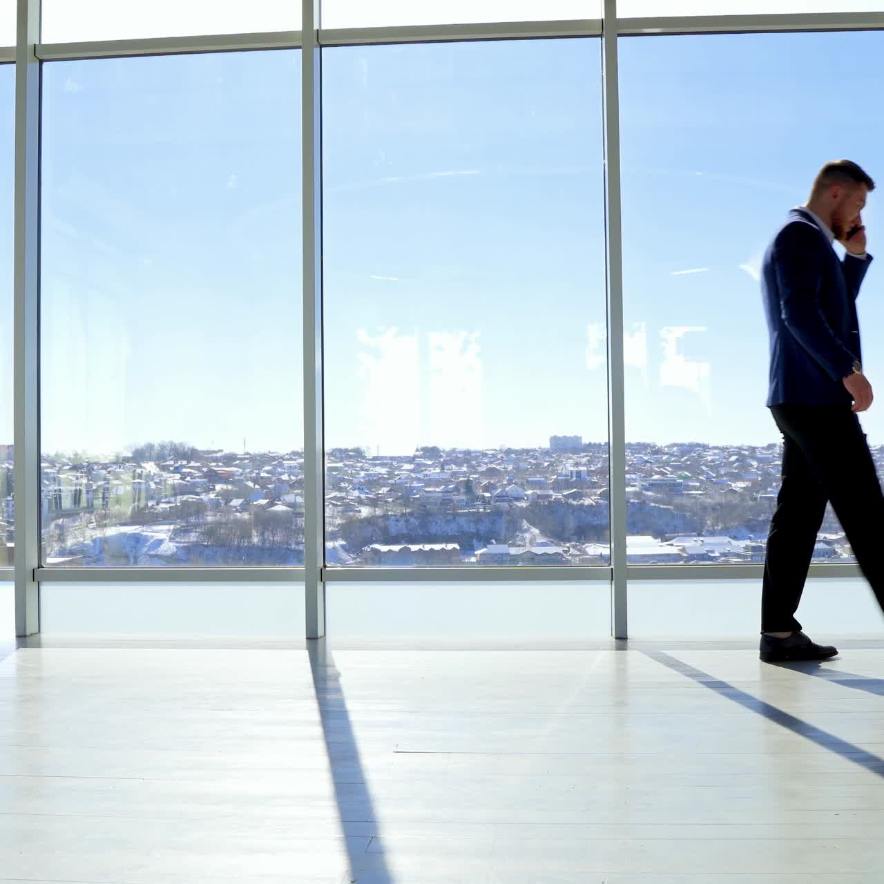 Young man talking on smartphone. Young businessman using the phone at office