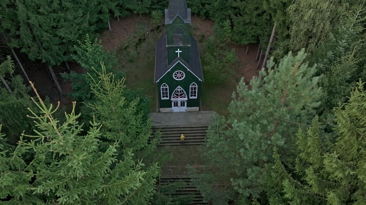 Drone view of a charming chapel tucked away in a serene landscape