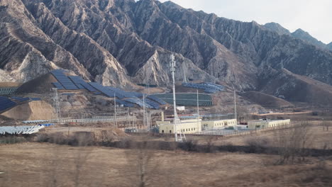 View-from-bullet-train-of-Chinese-solar-panels-on-desert-mountain