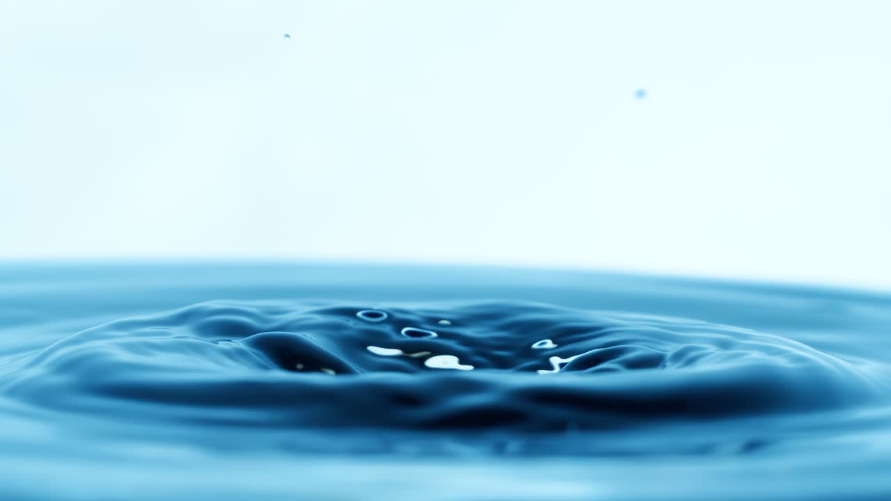 Drop of water falls into a drop of water in a super slow motion. Shot on super slow motion 1600 fps