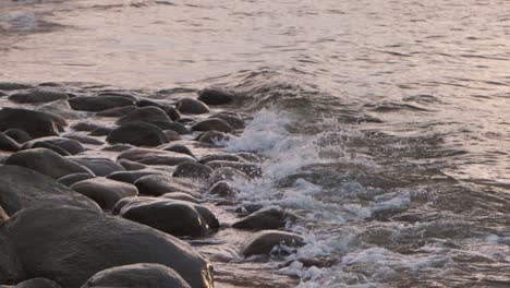 the sea waves wash away the big stones