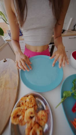 person preparing fresh spring rolls in the kitchen