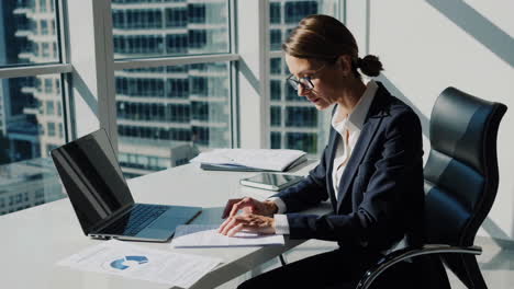 businesswoman working at her desk in modern office