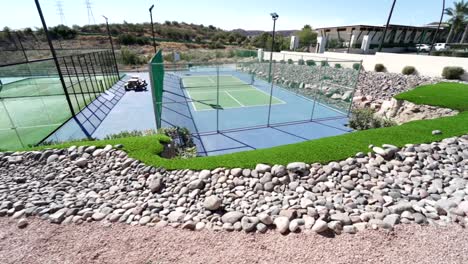 Slow-revealing-shot-of-newly-built-outdoor-padel-courts-in-summer