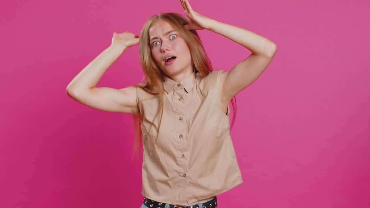 Funny comical woman making silly facial expressions and grimacing fooling around showing tongue