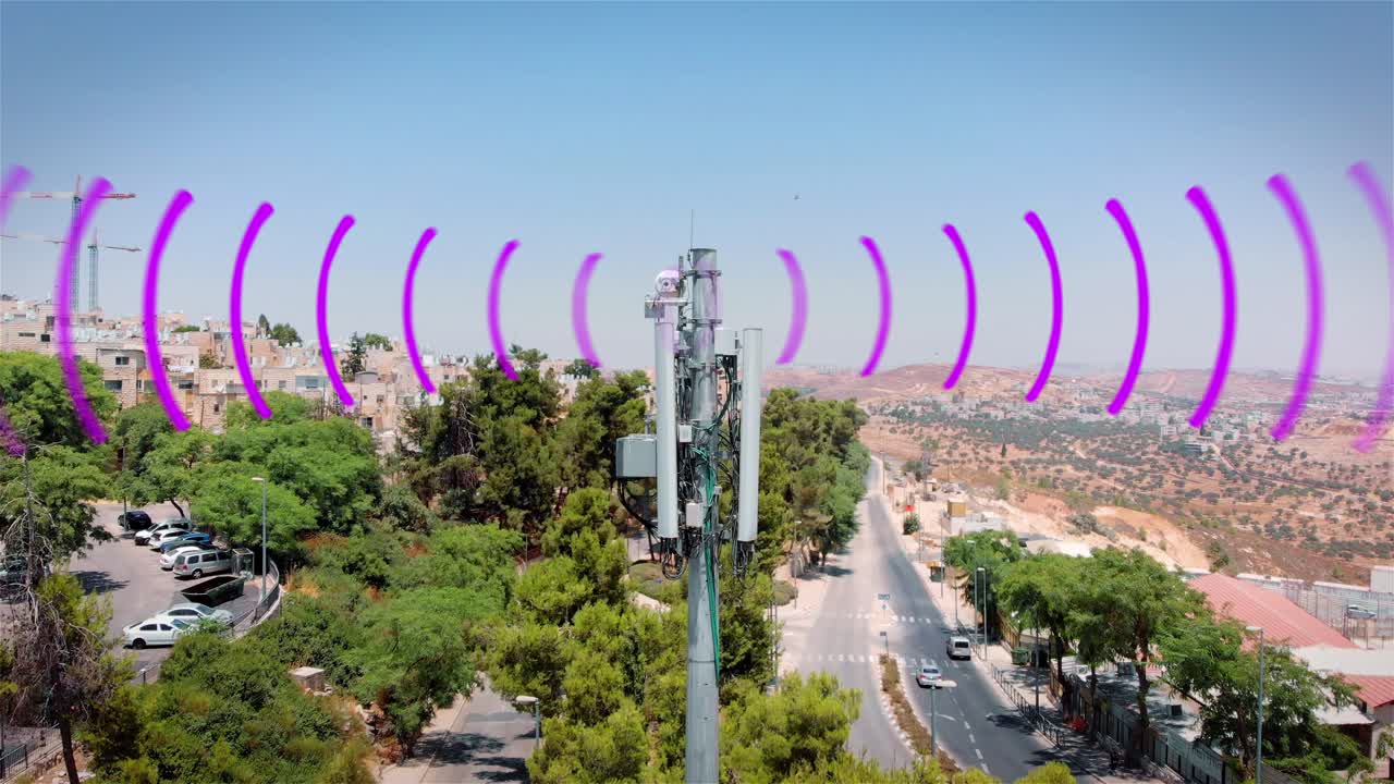 Cell Tower in Urban Israeli Landscape with Wireless Signals