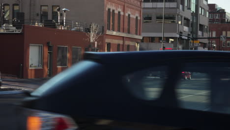 Smoke-Rising-From-Asphalt-Road-With-Vehicles-Driving-In-Denver,-Colorado-At-Daytime