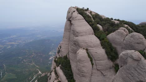 Tourists-at-the-top-of-a-mountain-peak-overlooking-the-city-of-Barcelona-under-grey-sky-due-to-climate-change,-Spain