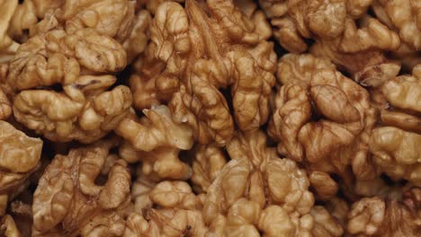 smooth camera movement over a handful walnuts.