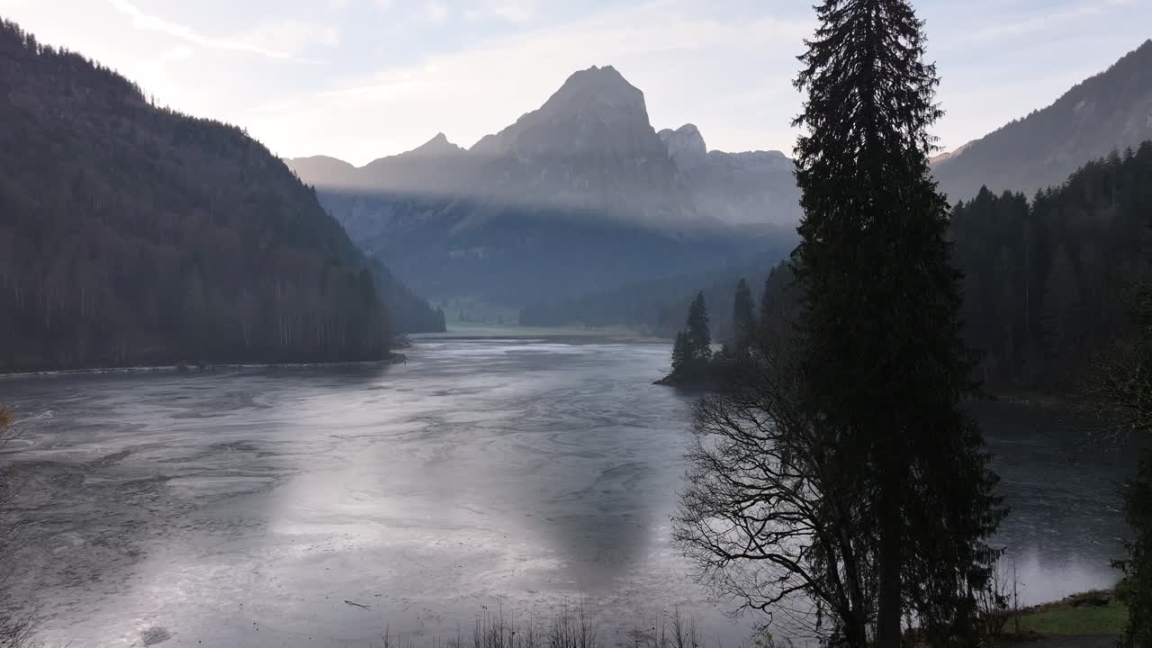 Drone discovering the frozen Obersee Lake, in the canton of St. Gallen, Switzerland.