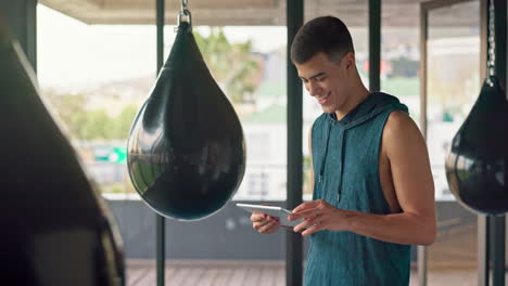 young man using digital tablet in gym