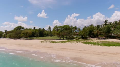 Aerial-rise-over-DR-beach-and-green-nature-golf-course