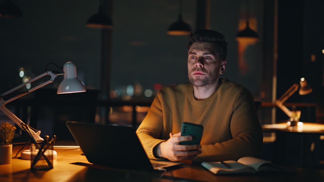Man working on laptop at night