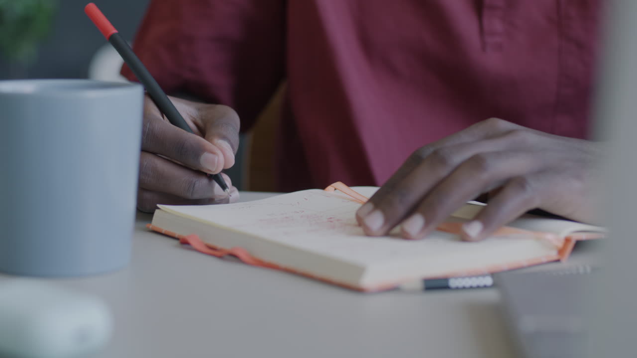 Person Writing in a Notebook