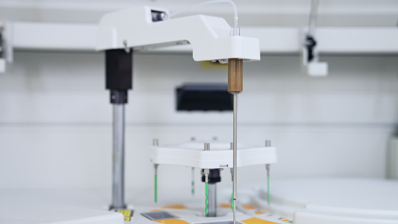 Machine detail is moving lowering and going up. Advanced equipment performing science medical analysis and testing. Close up. Blurred backdrop.