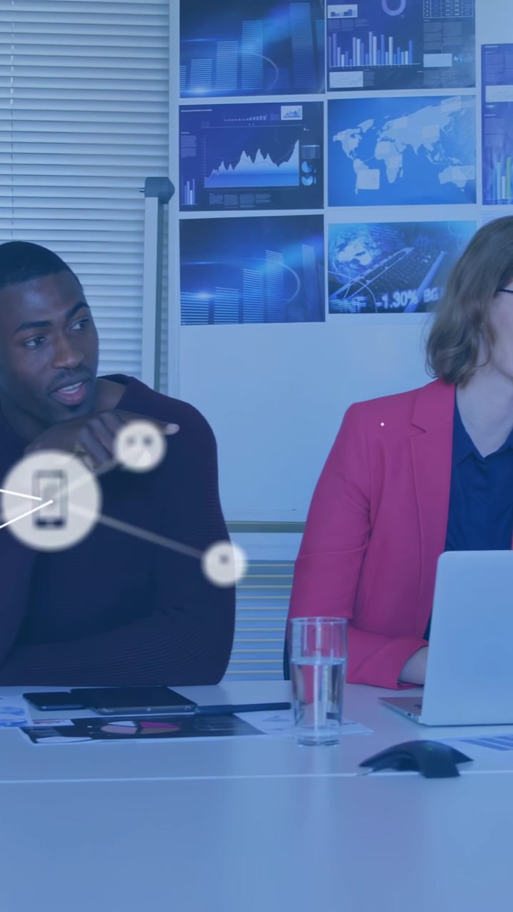 Vertical video: Woman using laptop in business, man gesturing starting overlay showing network