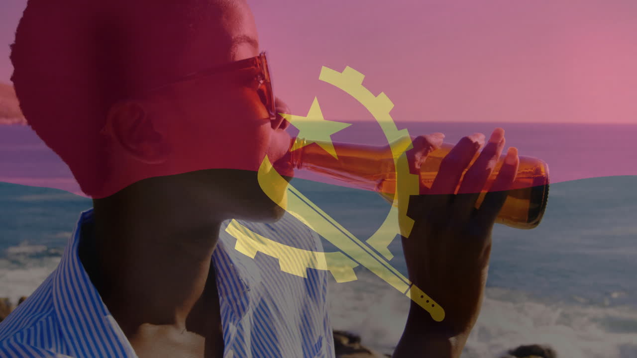 Drinking from bottle, person with Angola flag animation on coastal background