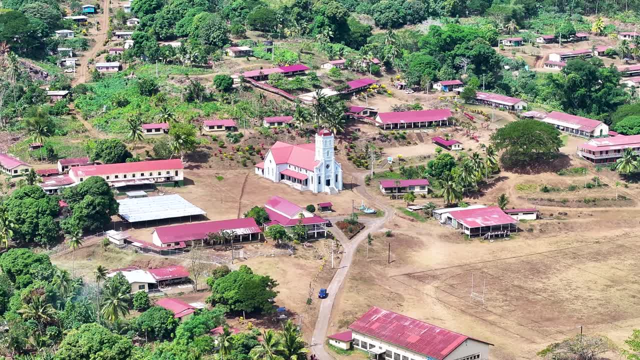 Wairiki Catholic Church and small settlement in tropical Pacific Island. Taveuni, Fiji. Drone panoramic